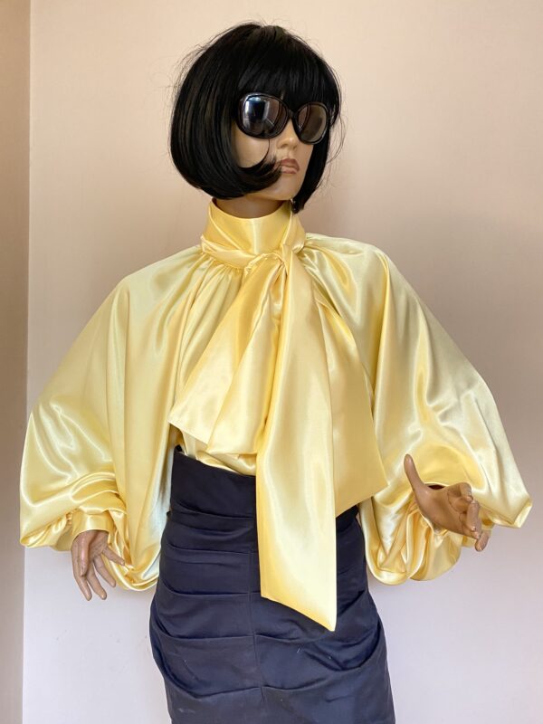 Yellow satin blouse with high neck, bow and puffy sleeves